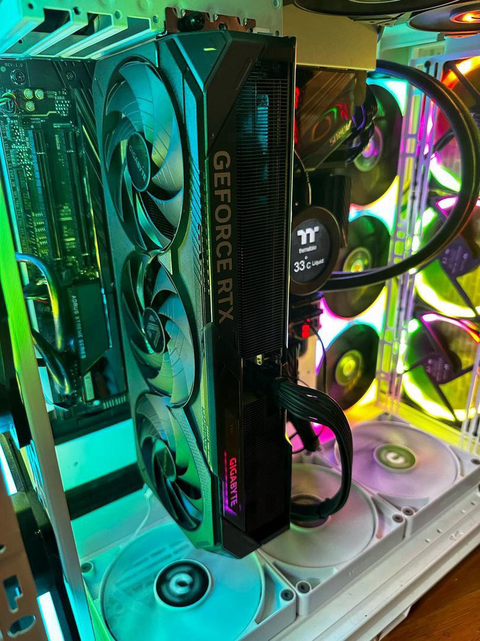 GIGABYTE WINDFORCE RTX 5090 installed in a high-end gaming PC case with RGB lighting.